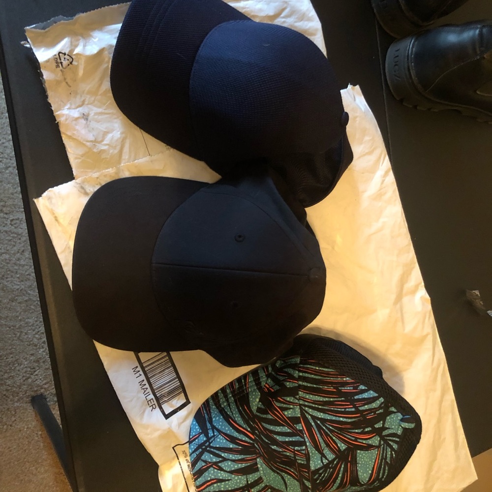 3 lululemon caps . 1 is a large .